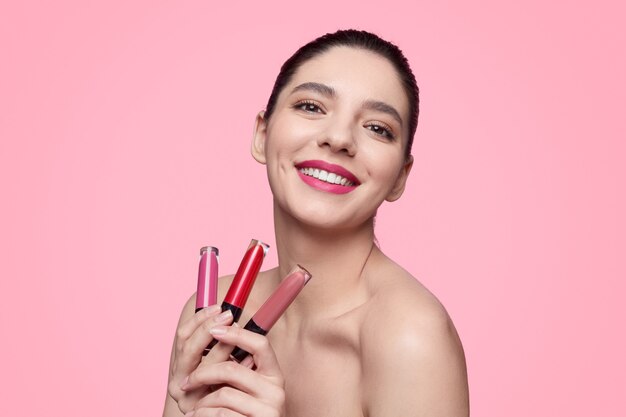 Happy young female against a pink background