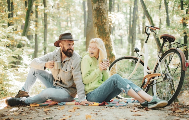 Happy young friends in park on sunny autumn day enjoying good weather