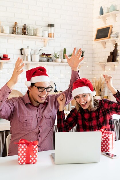 Happy young friends wearing Santa hat