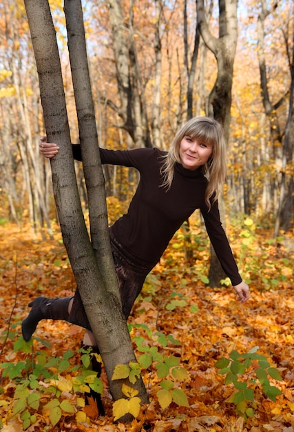 Happy young girl on autumn background