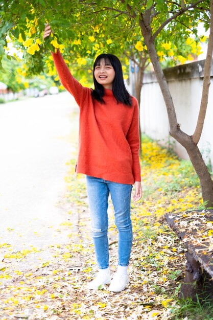 Happy young girl under the beautiful tree