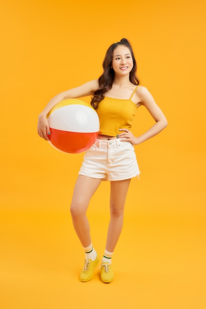 Happy young girl posing isolated over orange wall