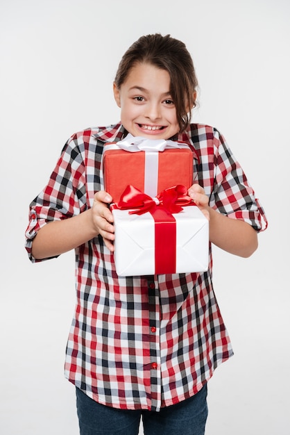 Happy young girl posing with two gifts