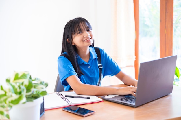 Happy young girl study at home with laptop ,home school.