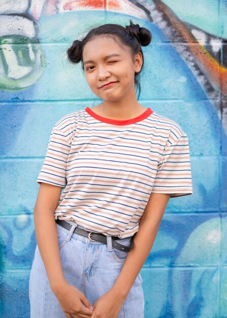 Photo happy young girl wear jean with colorful wall asian girl fashion girl