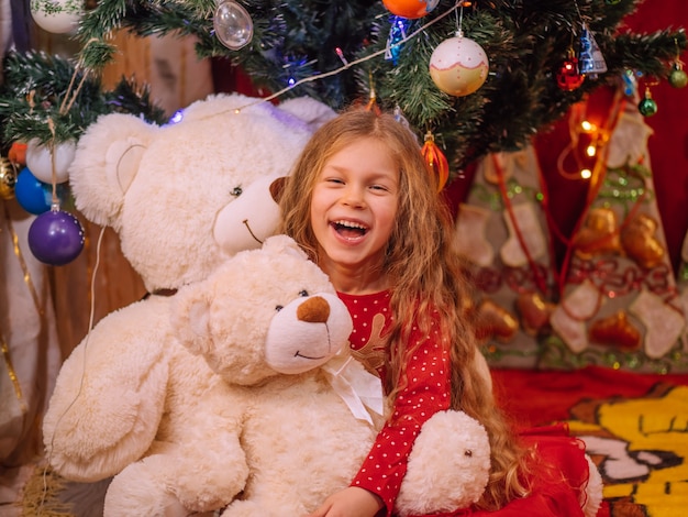 Happy young girl with bear at New Year time