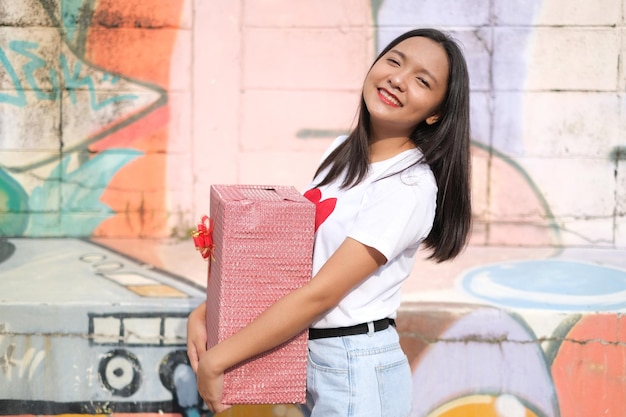 Happy young girl with gift box