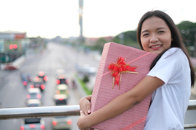 Happy young girl with gift box