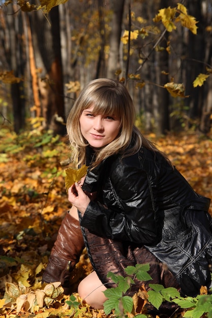 Happy young girl with yellow leaf