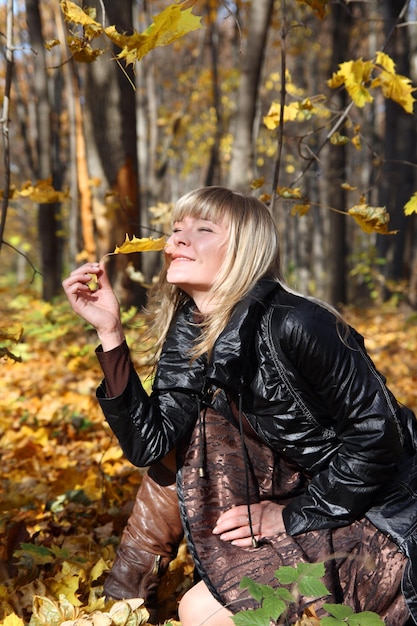 Happy young girl with yellow leaf