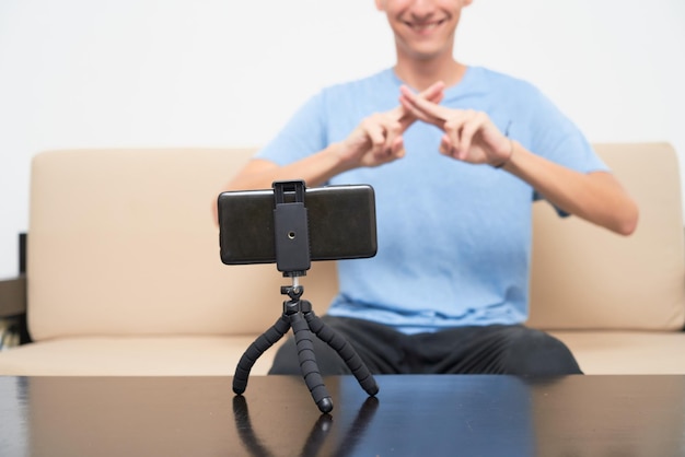 Happy young hispanic deaf man has a video call conversation via
a smartphone cell phone