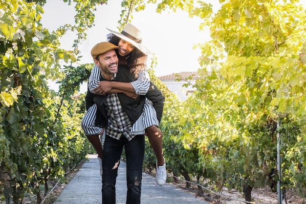 Happy young interracial couple on holiday in a vineyardxA