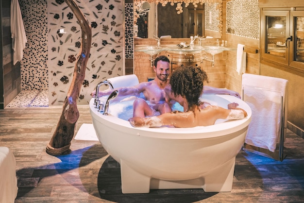 Happy young interracial couple relaxed enjoying their self in the jacuzzi xA
