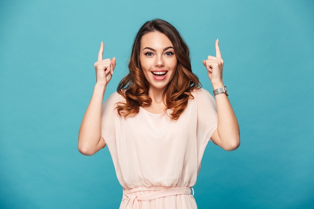 Happy young lady pointing.