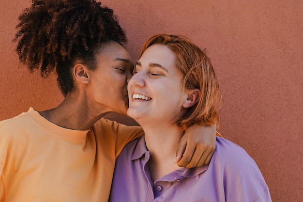 Happy young lesbian couple having tender moment outdoor Focus on the african girl face