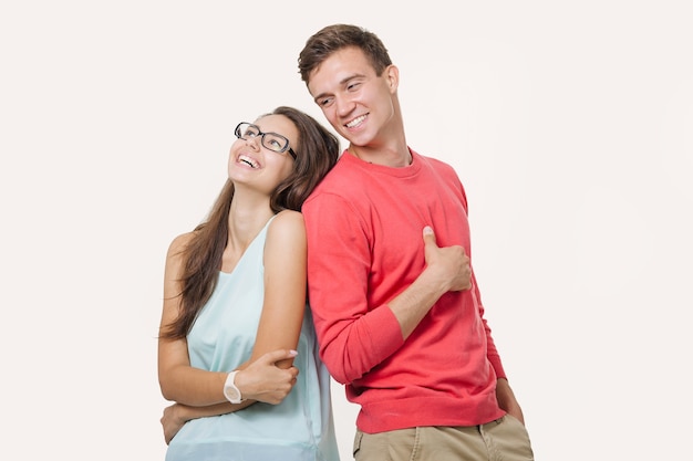 Happy young lovely couple standing back to back and laughing  Friendship and relationships.