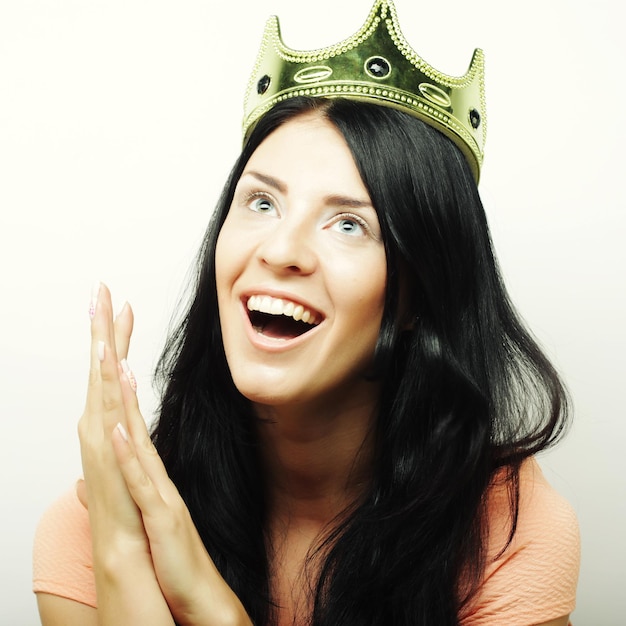 Happy young lovely woman with crown