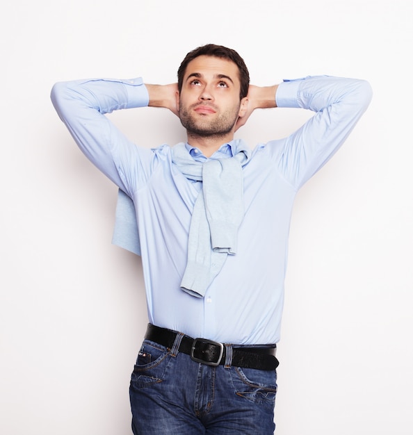 Happy young man in blue shirt.