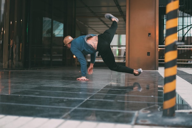 Happy young man dancing and jumping in the street xA