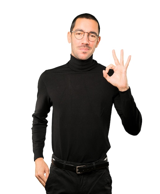 Happy young man doing an all right gesture