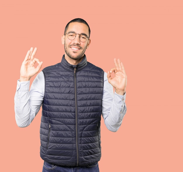 Happy young man doing a gesture of meditation