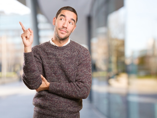 Happy young man doing a gesture of show