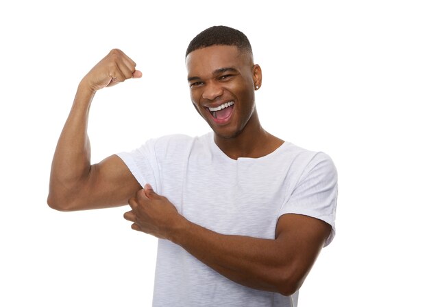 Happy young man flexing bicep muscle