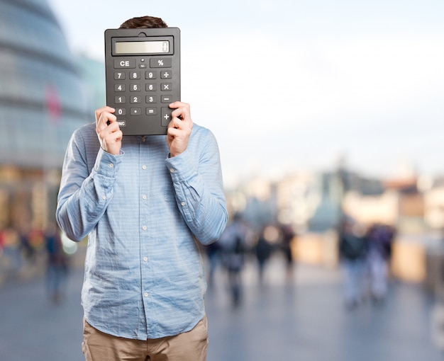 Happy young man holding a calculator