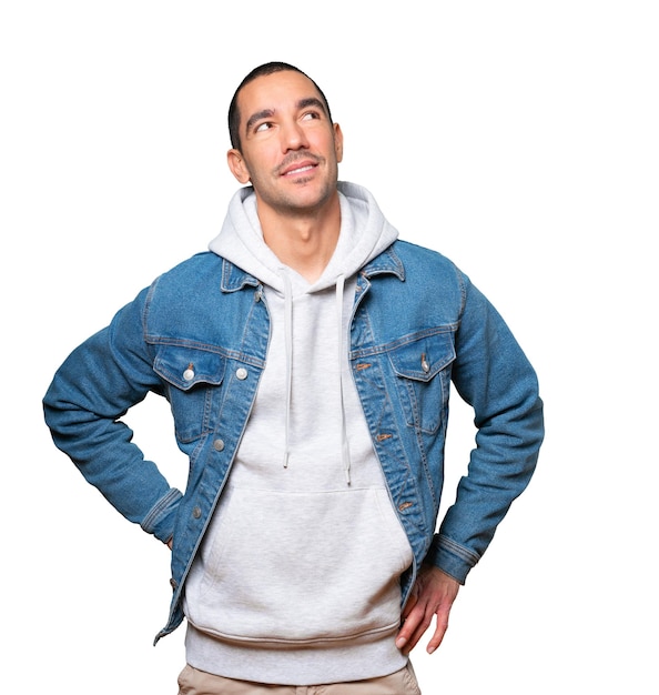 Happy young man looking against background