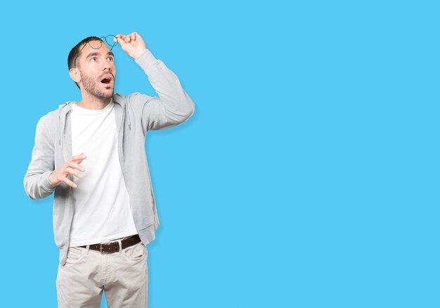 Happy young man looking up gesture