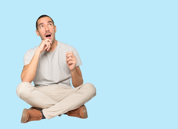 Happy young man looking up gesture