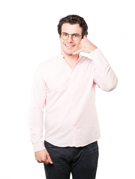 Happy young man making a gesture of calling with the hand