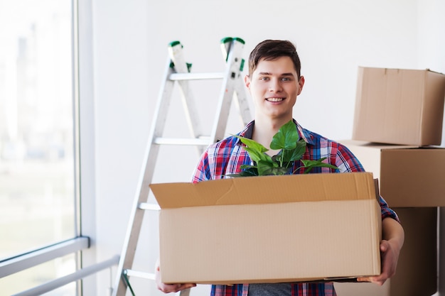 Happy young man moving to new home