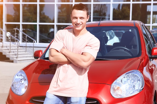 Photo happy young man near new car outdoors