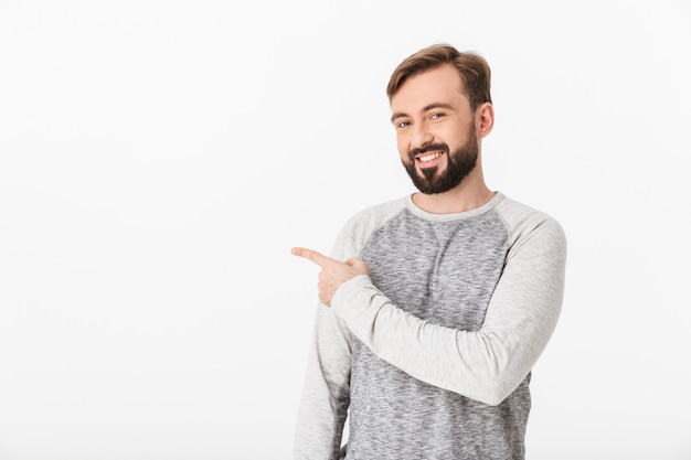 Happy young man pointing.