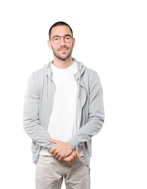 Happy young man posing against background