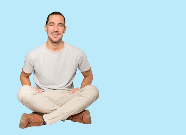 Happy young man posing against background