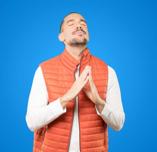 Happy young man praying gesture