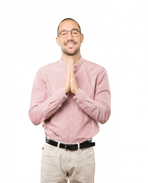 Happy young man praying gesture