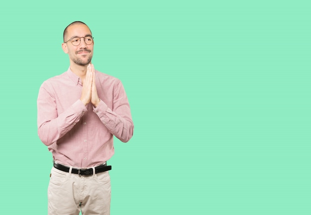 happy young man praying gesture