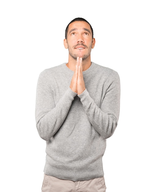 Happy young man praying gesture