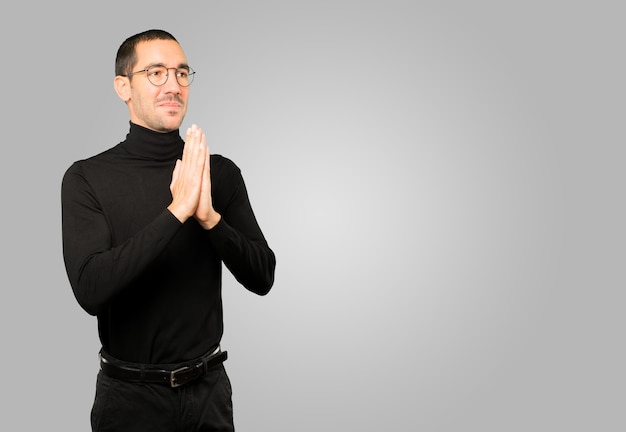 Happy young man praying gesture