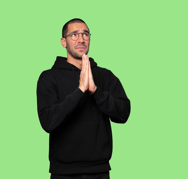 Happy young man praying gesture