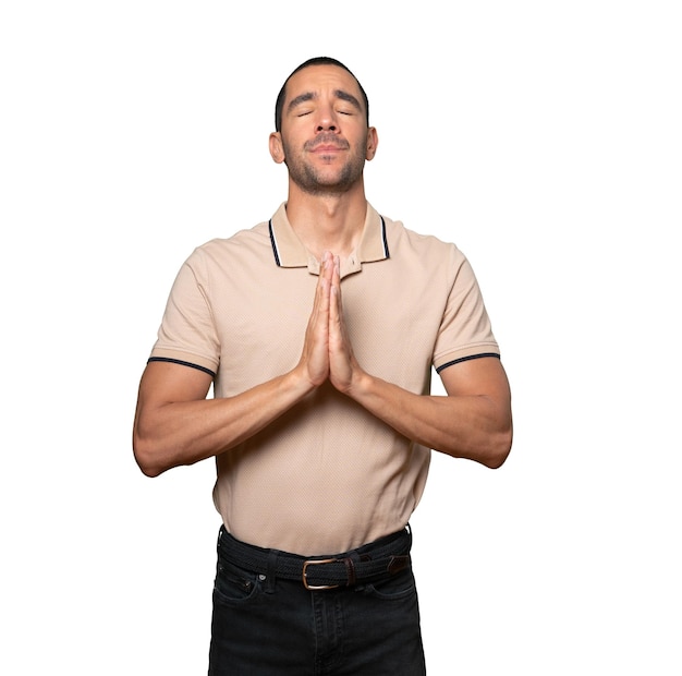 Happy young man praying gesture