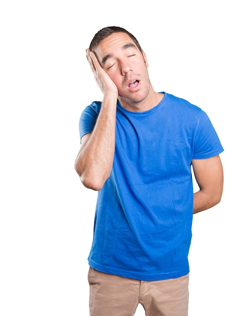 Happy young man sleeping against white background