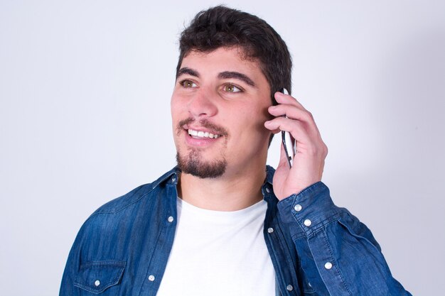 Happy young man talking on mobile phone