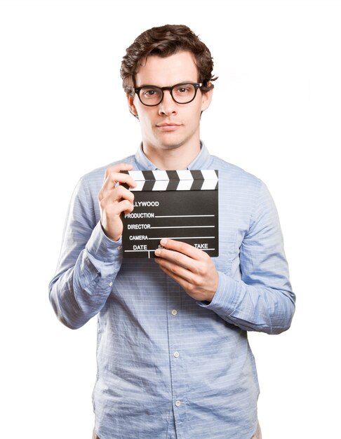 Happy young man using a clapperboard