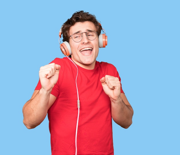 Happy young man using a headphones