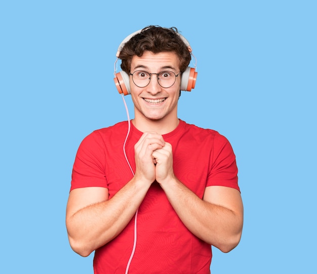 Photo happy young man using a headphones