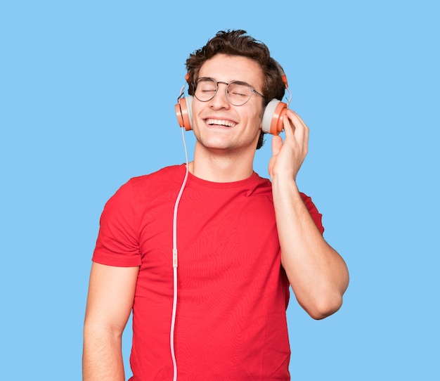 Happy young man using a headphones